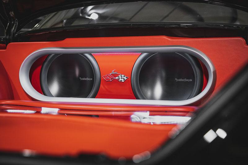 Rockford Fosgate subwoofers installed in a car trunk with red interior design